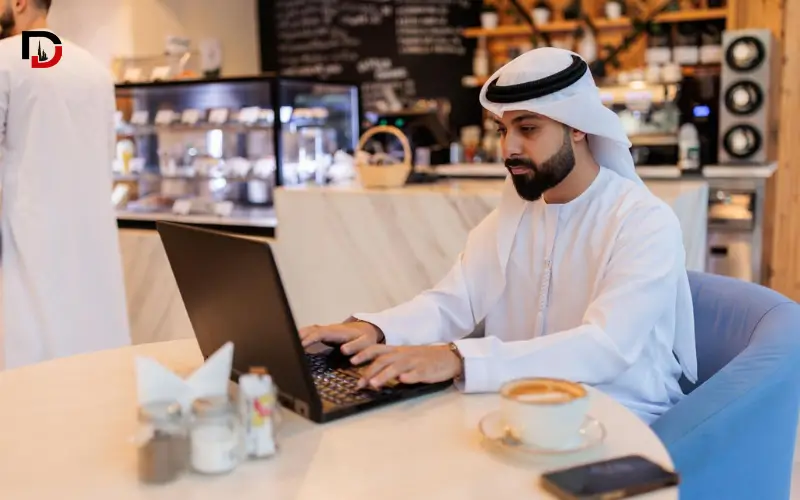 - UAE resident using a laptop in a Dubai café